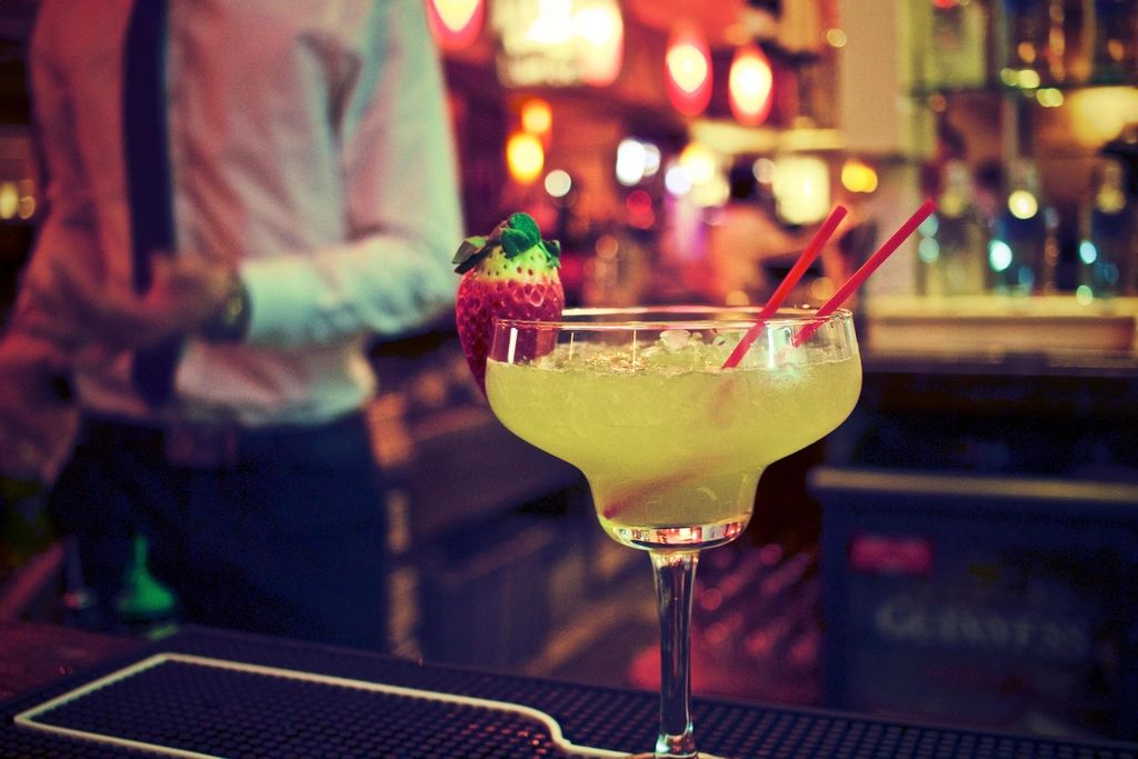 A cocktail being finished at the bar
